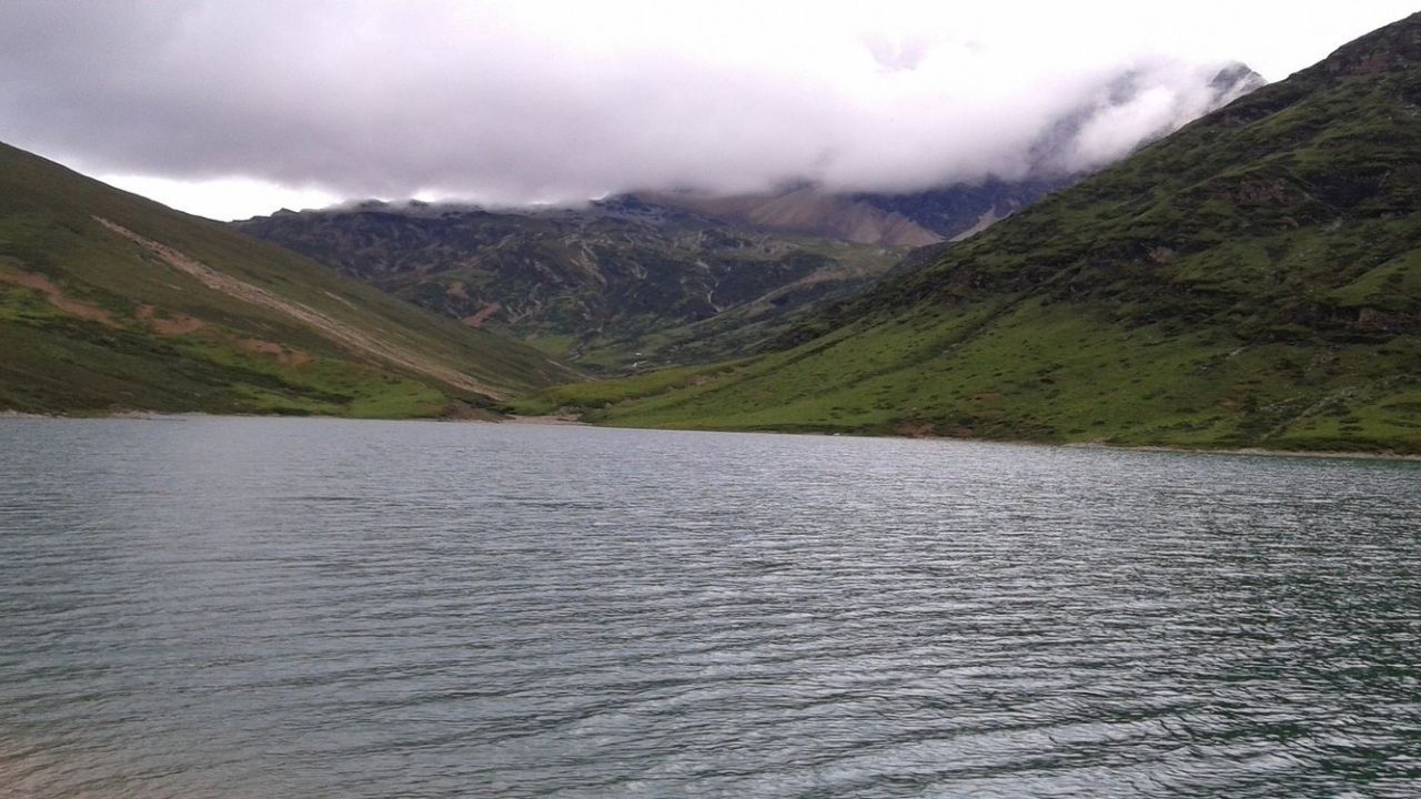 Jomolhari Trek in Bhutan with scenic mountain trails and a clear waterbody nearby.