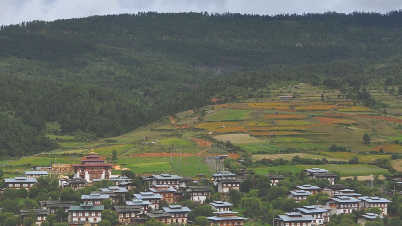 Peaceful view of Bumthang Valley with ancient Buddhist temples, forested hills, and a quiet riverside landscape reflecting Bhutan’s spiritual heartland.