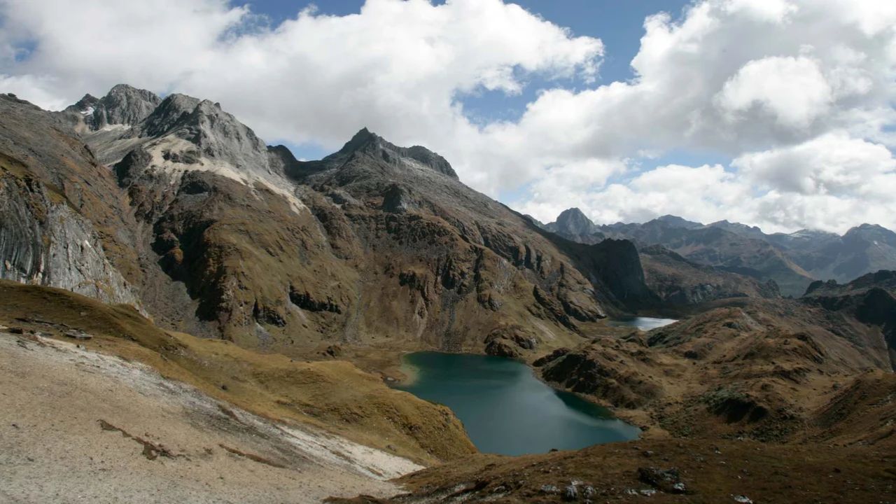 Mountain lake surrounded by rugged Himalayan peaks in Bhutan.