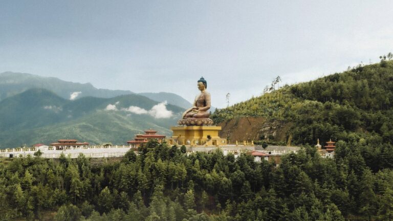 Buddha Dordenma statue overlooking forested mountains in Thimphu, Bhutan.