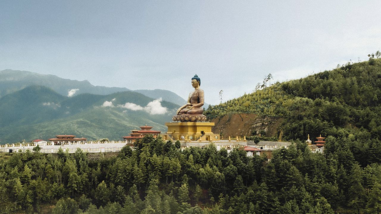 Buddha Dordenma statue overlooking forested mountains in Thimphu, Bhutan.