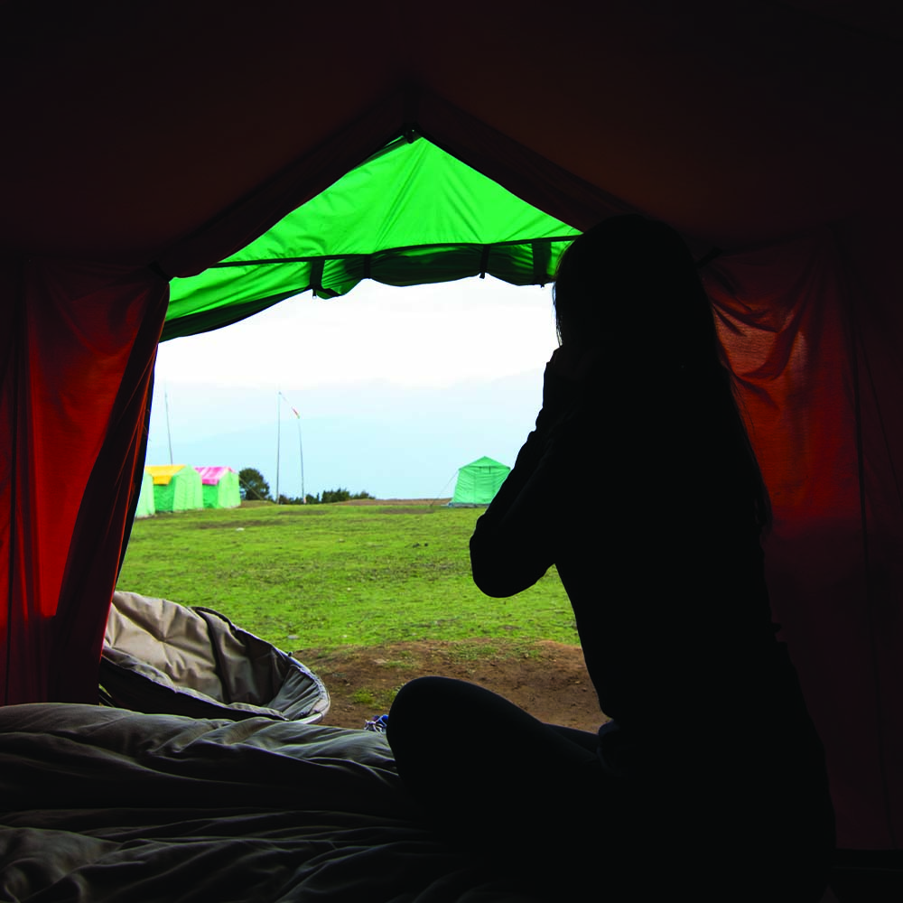 Traveler resting inside a glamping tent during the Bumdra Trek in Bhutan