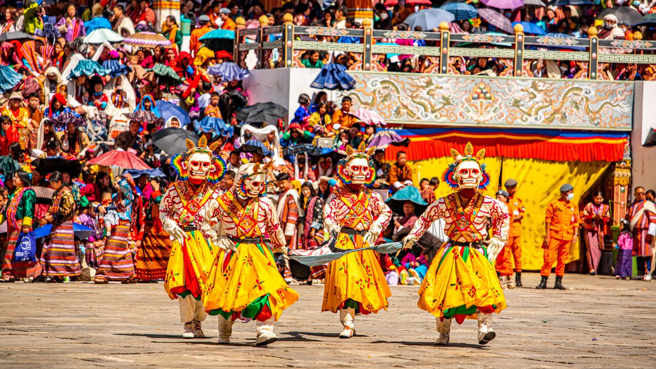 Thimphu Tshechu masked dancer performing a traditional festival dance