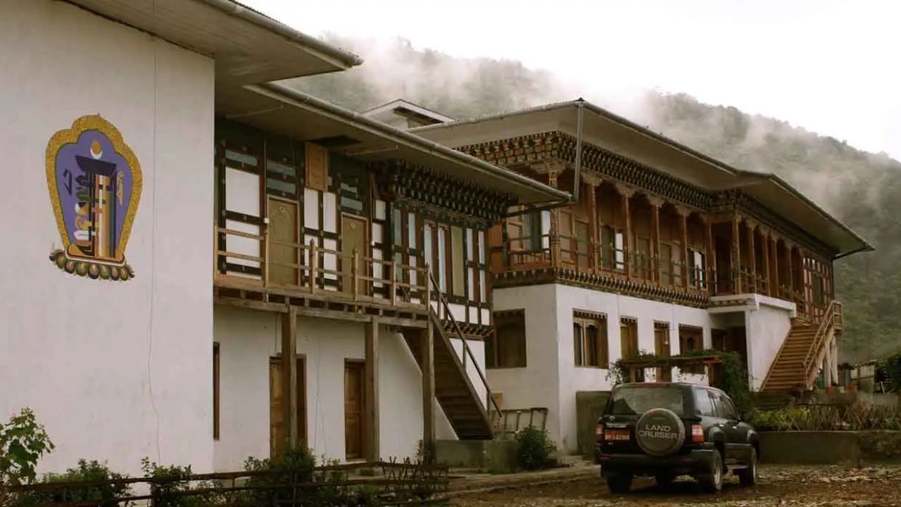 Trogon Villa in eastern Bhutan surrounded by forested hills, offering a peaceful birdwatching retreat with traditional Bhutanese architecture and nature views.