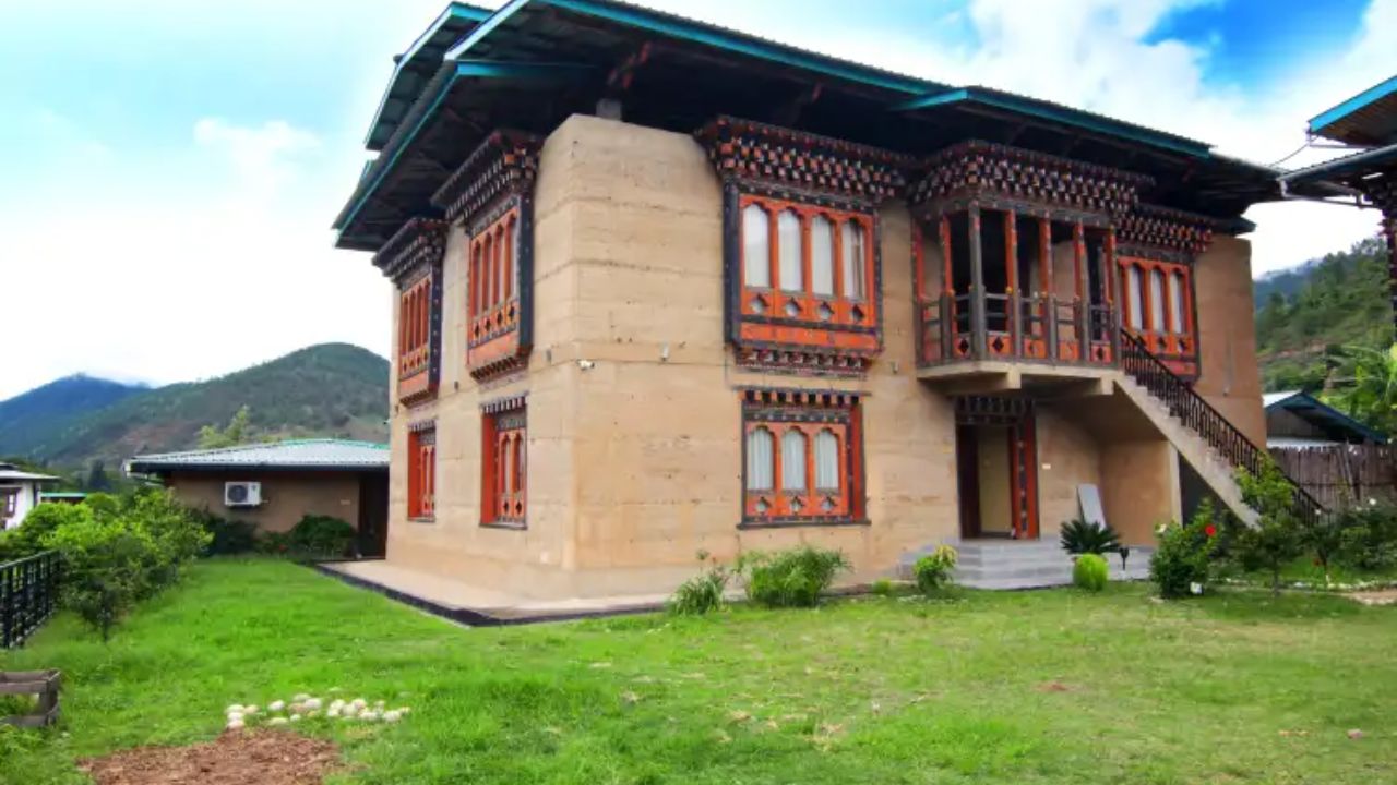 Spirit Village Lodge in Punakha set amid rice fields and gentle hills, offering a tranquil village-style stay with traditional Bhutanese architecture.